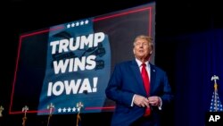 Republican presidential candidate and former President Donald Trump takes the stage at a caucus night party in Des Moines, Iowa, Jan. 15, 2024.