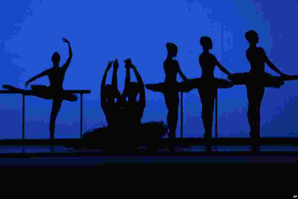 American Ballet Theater&#39;s dancers are silhouetted as they rehearse for the opening night at the Shanghai Grand Theater in Shanghai, China.