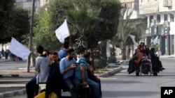 Palestinians on donkey carts hold up white flags trying to prevent being shot, while fleeing Gaza City on the al-Rimal neighborhood, central Gaza City.