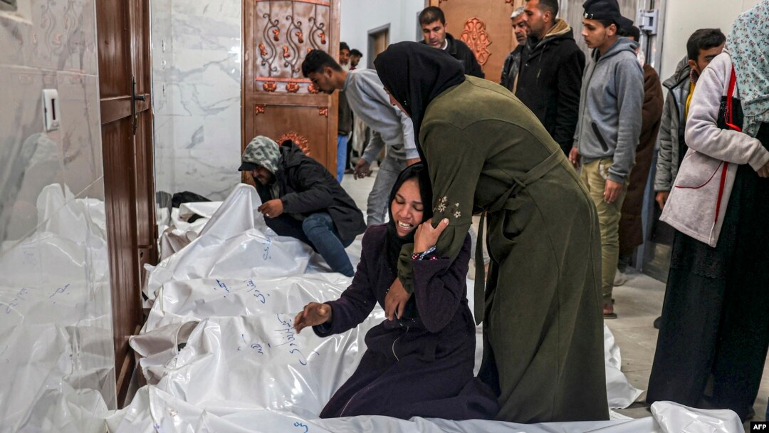 Relatives of Palestinians killed in an overnight Israeli bombardment mourn over their bodies at the European hospital morgue in Khan Younis, in the southern Gaza Strip, March 5, 2024.