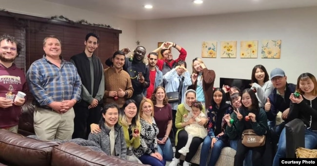 FILE - Professor Sarah Mannix and international students from the English Language Center at Old Dominion University celebrate Thanksgiving at her house in 2023.