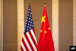 FILE - U.S. and Chinese flags are set up before a meeting between Treasury Secretary Janet Yellen and Chinese Vice Premier He Lifeng in Beijing, on July 8, 2023.