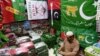 A shopkeeper arranges flags of political parties at his shop ahead of the upcoming general elections in Karachi on Jan. 3, 2024.