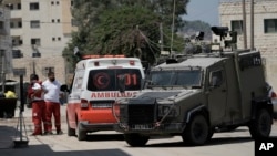 Members of the Israeli forces inside an armored vehicle check an ambulance during a military operation in the West Bank city of Jenin, Aug. 28, 2024.