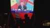 FILE - China's President Xi Jinping is pictured on a big screen during an evening news program showing Xi's keynote speech at the opening ceremony of the 8th Forum on China-Africa Cooperation at a mall in Beijing, Nov. 30, 2021. 