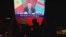 FILE - China's President Xi Jinping is pictured on a big screen during an evening news program showing Xi's keynote speech at the opening ceremony of the 8th Forum on China-Africa Cooperation at a mall in Beijing, Nov. 30, 2021. 