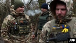 Ukrainian servicemen take a break on the frontline near the town of Bakhmut, Donetsk region, on Nov. 18, 2023, amid the Russian invasion of Ukraine.