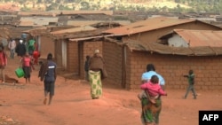 FILE - Refugees from various nationalities walk through Dzaleka refugee camp in Dowa District Central region of Malawi, on June 20, 2018.