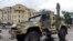 A serviceman stands atop an armored vehicle of the Wagner Group military company, guarding an area at the HQ of the Southern Military District, Rostov-on-Don, Russia, June 24, 2023.