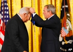 FILE - President George W. Bush, right, presents the 2007 National Medal of Arts to author N. Scott Momaday, during a ceremony in the East Room of the White House, Nov. 15, 2007.