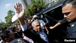 FILE - Former Malaysian Prime Minister Muhyiddin Yassin waves outside Kuala Lumpur Court Complex in Kuala Lumpur, March 10, 2023. 