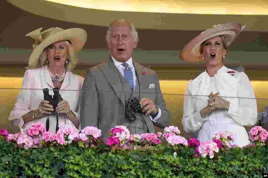 Britain's King Charles III, Camilla, the Queen Consort and Sophie, Duchess of Edinburgh, right, react as they watch a race at day two of the Royal Ascot horse racing meeting, at Ascot Racecourse in Ascot, England.