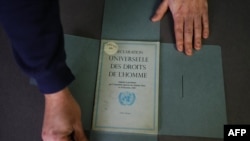 This photograph taken on December 9, 2023, shows the cover of a document from the Department of Information of the United Nations, dated March 1949, that says "Declaration Universelle des Droits de l'Homme" — the Universal Declaration of Human Rights.