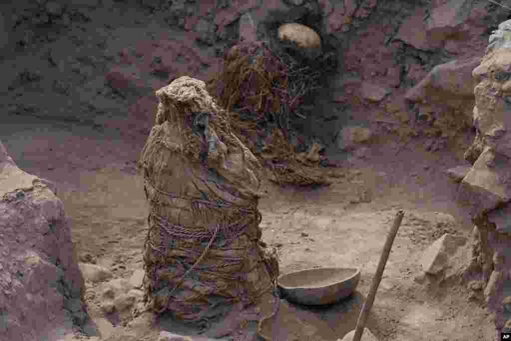 One of five mummies discovered by Peruvian archeologists stands in the El Rimac neighborhood of Lima, Nov. 20, 2023.