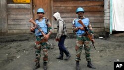 FILE - UN soldiers stand guard in Goma, Democratic Republic of Congo, on Nov. 30, 2012. 