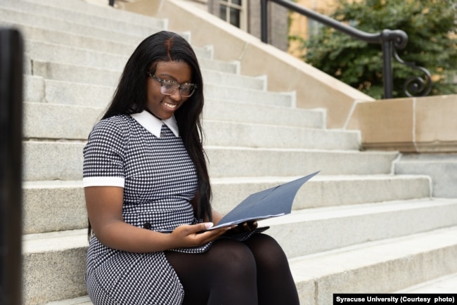 A student at Syracuse University reviews paperwork before a meeting with a career counselor. (Photo courtesy of Syracuse University)