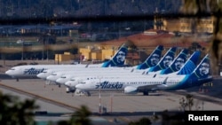 FILE - Alaska Airlines commercial airplanes are parked off to the side of the airport in San Diego, California, Jan. 18, 2024, as the the National Transportation Safety Board continues its investigation of the Boeing 737 Max aircraft. 