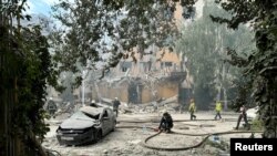 Rescuers work at the site of a Russian missile strike, amid Russia's attack on Ukraine, in Kharkiv, Ukraine, Aug. 6, 2024.