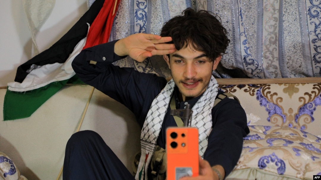 Rashed Al-Haddad, 19, a Yemeni TikToker and influencer, who has been dubbed 'Tim Houthi Chalamet' by Western internet wags for his resemblance to actor Timothee Chalamet, talks to a friend on the phone in Sanaa on Jan. 18, 2024.