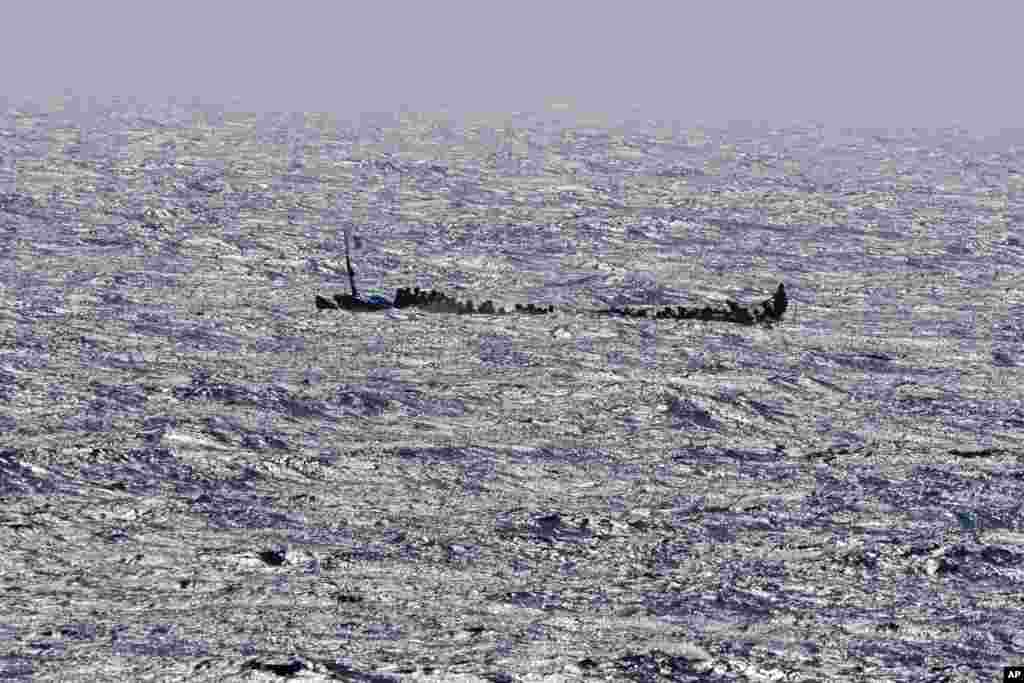 Migrants crowd a wooden boat as they sail to the port in La Restinga on the Canary island of El Hierro, Spain, Aug. 18, 2024.&nbsp;Emergency services on Spain&#39;s Canary Islands say 175 migrants have arrived in a boat on the Canary Island of El Hierro, after a seven-day sailing from the coast of Senegal.&nbsp;