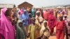 FILE - People wait for news about the kidnapped LEA Primary and Secondary School Kuriga students, in Kuriga, Kaduna state, Nigeria, March 9, 2024. 