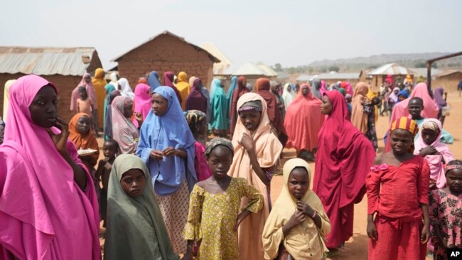 People wait for news about the kidnapped LEA Primary and Secondary School Kuriga students in Kuriga, Kaduna, Nigeria, March 9, 2024.
