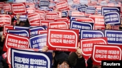 FILE - Doctors chant slogans during a rally to protest against the government's plan to increase medical school enrollment in Seoul, South Korea, March 3, 2024.