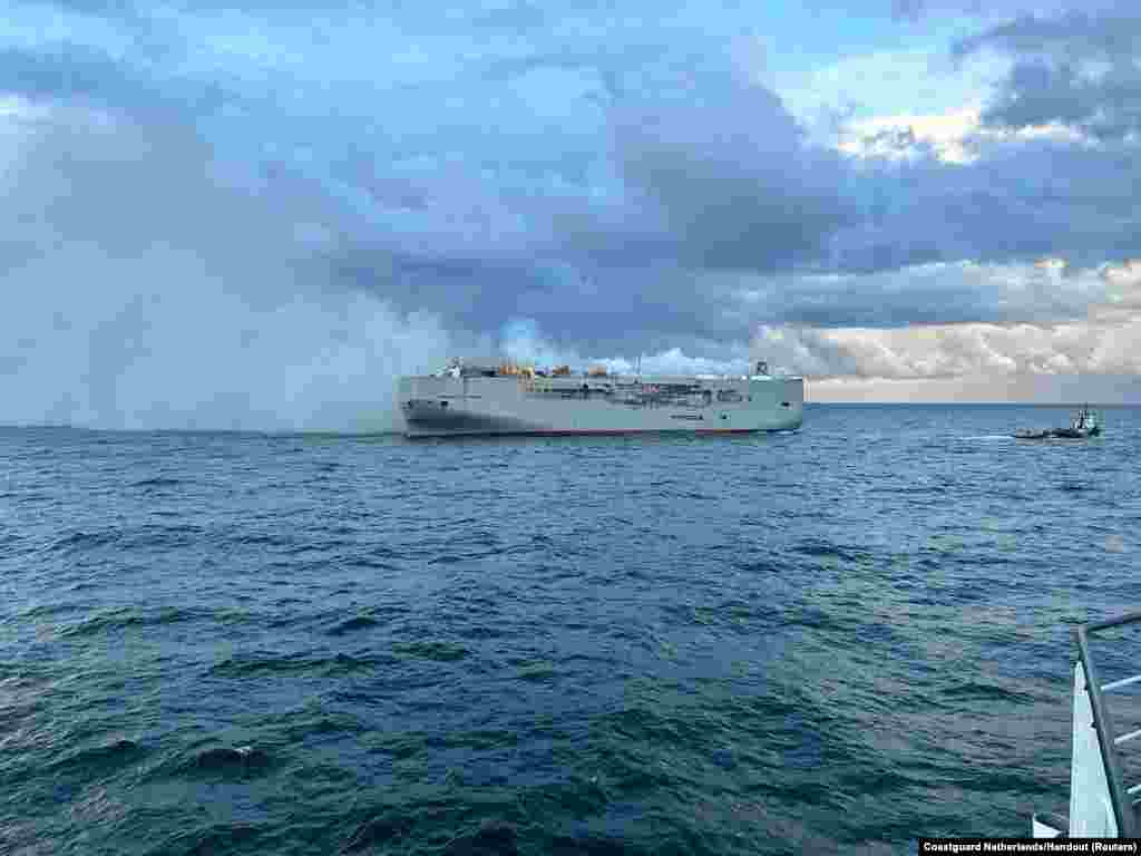 Smoke rises as a fire broke out on the cargo ship Fremantle Highway, at sea.