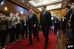Menteri Luar Negeri AS Antony Blinken (kiri) berjalan dengan Menteri Luar Negeri China Qin Gang (kanan) menjelang pertemuan di Diaoyutai State Guesthouse di Beijing pada 18 Juni 2023. (Foto: AFP)