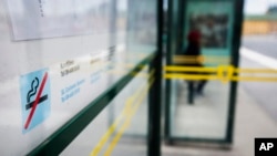 FILE - A no smoking sign is seen at a bus stop in Stockholm, Sweden, June 25, 2019.