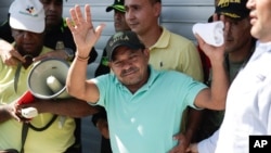 Luis Manuel Diaz waves outside his home in Barrancas, Colombia, after he was released by kidnappers, Nov. 9, 2023. Diaz, father of Liverpool soccer player Luis Diaz, was kidnapped on Oct. 28 by the guerrilla group National Liberation Army, or ELN. 