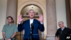 Speaker of the House Kevin McCarthy is joined by his top negotiators on the debt limit, Rep. Garret Graves, left, and Rep. Patrick McHenry, as he talks to reporters at the Capitol, May 28, 2023. 