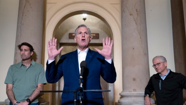 Speaker of the House Kevin McCarthy is joined by his top negotiators on the debt limit, Rep. Garret Graves, left, and Rep. Patrick McHenry, as he talks to reporters at the Capitol, May 28, 2023.