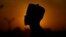 FILE - An atheist stands against the sunset sky in Kano, Nigeria, July 14, 2023. 