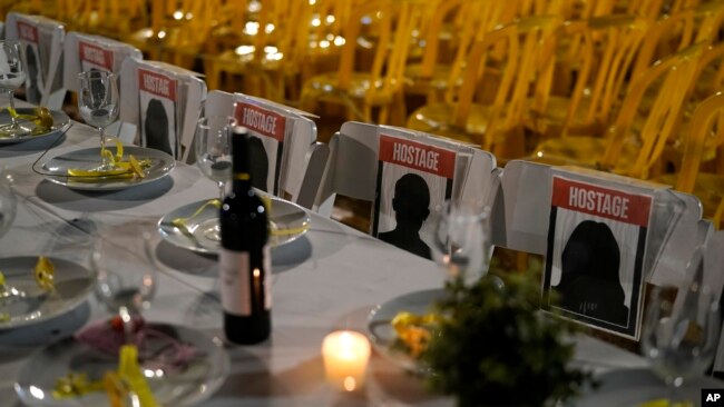 A table is set for hostages being held in the Gaza Strip, in a show of solidarity, in Tel Aviv, Israel, Nov. 25, 2023.