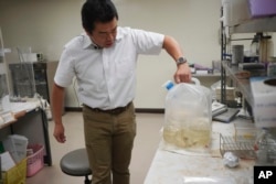 University of Tokyo environmental chemistry professor Katsumi Shozugawa shows the groundwater he collected from a no-go zone just outside of the Fukushima Daiichi nuclear plant complex on July 19, 2023, in Tokyo. Shozugawa said radioactivity of the treated water is so low that once it hits the ocean it will quickly disperse and become almost undetectable.