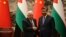 China's President Xi Jinping, right, and Palestinian President Mahmoud Abbas shake hands after a signing ceremony at the Great Hall of the People in Beijing, June 14, 2023.