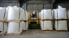 FILE - A worker moves bags of lithium carbonate at an Albemarle Corp. facility, Oct. 6, 2022, in Silver Peak, Nevada. The North Carolina company will pay millions to settle foreign bribery allegations, the U.S. Justice Department said Sept. 29, 2023.