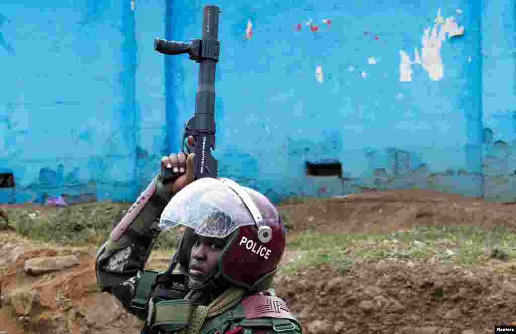 A riot police officer carries his gun after dispersing supporters of Kenya&#39;s opposition leader Raila Odinga of the Azimio La Umoja (Declaration of Unity) One Kenya Alliance, during an anti-government protest dubbed &quot;Saba Saba &nbsp;(7th of July) People&#39;s March,&quot; in Nairobi, Kenya.