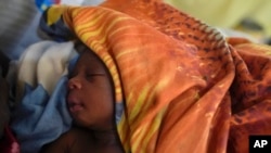 A newborn lies on a bed in the Doctors Without Borders-run hospital in Bentiu, South Sudan, June 24, 2024. South Sudan's health system suffers, even though the relative peace gives many women easier access to care.