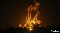 Flares are fired by Israeli forces as smoke rises during Israeli strikes, amid the ongoing conflict between Israel and Palestinian Islamist group Hamas, in Gaza City Nov. 5, 2023.