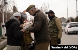 Jammu and Kashmir police frisk locals in the Wazir Bagh neighborhood of Srinagar, March 5, 2024. The area is witnessing a heavy deployment of security forces before Prime Minister Narendra Modi addresses a gathering at Bakshi Stadium.