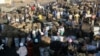 FILE - People gather to buy charcoal at a busy market in Lusaka, Zambia, July, 5, 2021. The French government said on June 22, 2023, that Zambia reached a deal with China and several other government creditors to restructure $6.3 billion in loans. 