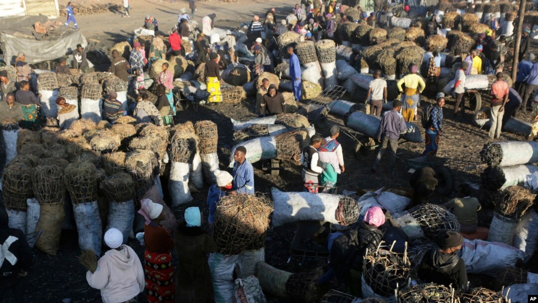 FILE - People gather to buy charcoal at a busy market in Lusaka, Zambia, July, 5, 2021. The French government said on June 22, 2023, that Zambia reached a deal with China and several other government creditors to restructure $6.3 billion in loans. 