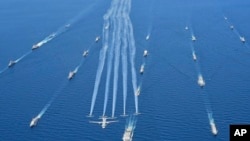 FILE - Indonesian naval aircraft fly past warships during the 4th Multilateral Naval Exercise Komodo 2023 in Makassar waters, Indonesia, June 8, 2023. Navies from more than 30 countries, including the U.S. and China, took part in the noncombat exercise.