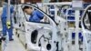 FILE - Employees work on assembling vehicles at a plant of SAIC Volkswagen in Urumqi, Xinjiang, China, on Sept. 4, 2018. (China Daily via Reuters)