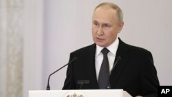 Russian President Vladimir Putin delivers a speech at the St. George Hall of the Grand Kremlin Palace in Moscow, Dec. 8, 2023. The announcement comes a day after lawmakers set the election date.