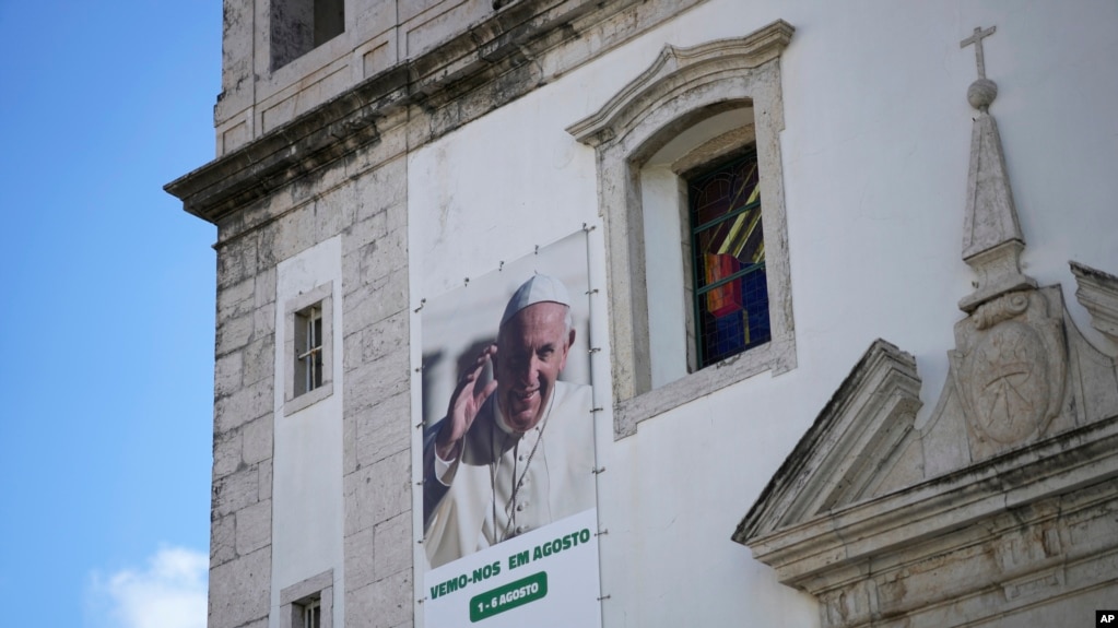 A banner on the outside of a church announces international World Youth Day from August 1 to 6, in Lisbon, July 25, 2023. Pope Francis will attend the event that is expected to bring hundreds of thousands of young Catholic faithful to Lisbon. 