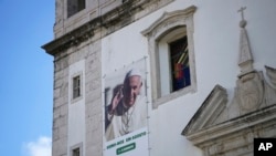 A banner on the outside of a church announces international World Youth Day, August 1-6, in Lisbon, Portugal, July 25, 2023. Pope Francis will attend the event that is expected to draw thousands of young Catholics.
