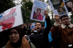 FILE - Protesters chant slogans as they hold posters and pictures of victims during a protest against China's brutal crackdown on ethnic Uyghurs, in front of the Chinese Consulate in Istanbul, Turkey, Nov. 30, 2022.